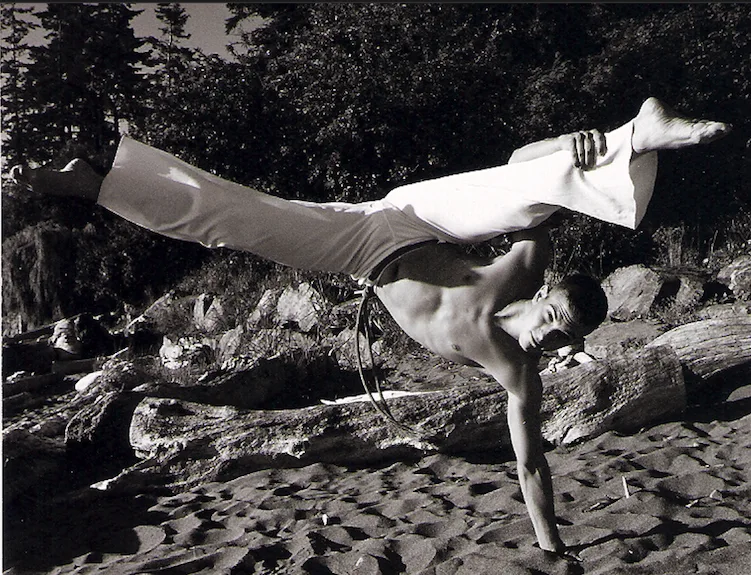 Paul at sixteen, mid-leap on a beach, black and white